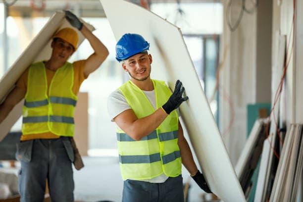 Handyman using a cordless drill to mount a shelf bracket