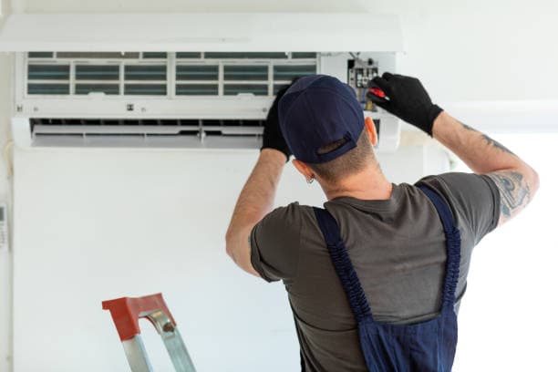 HVAC technician servicing a residential furnace