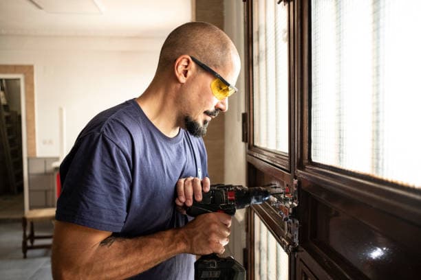 Locksmith hands rekeying a residential deadbolt